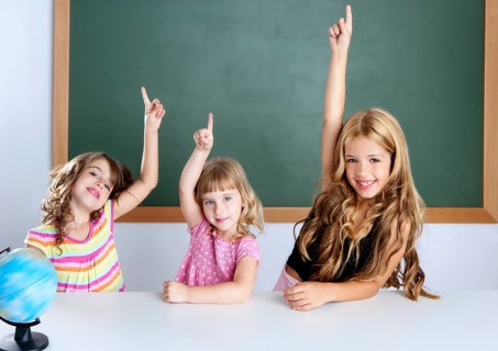Kids student clever girls group in classroom raising hand finger