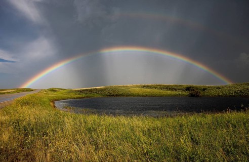 Saskatchewan Storm Rainbow overfield and slough pond hail