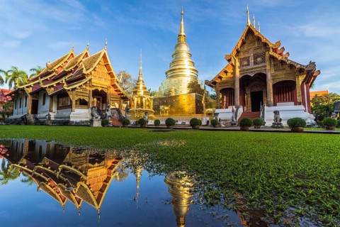 Wat Phra Singh temple, blue sky and reflection in water. Chiang Mai, Thailand, Asia