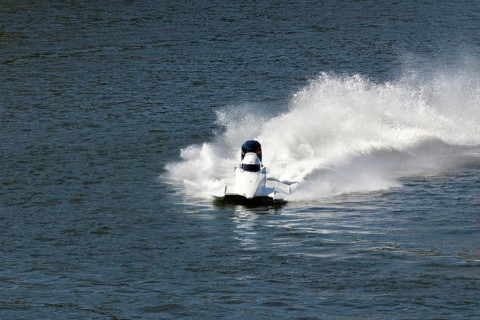 White Speedboat Making Turn with Splashes of Water during Race on Championship