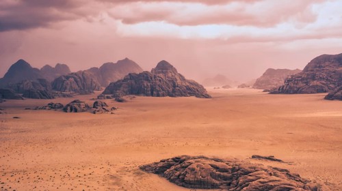 Storm and rain clouds over the desert landscape of Wadi Rum in Jordan. Panoramic shot 16:9 aspect