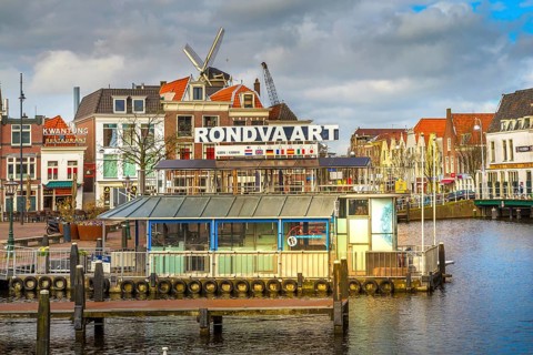 Leiden, Netherlands, April 7, 2016: Panorama with traditional dutch houses, harbour at canal and