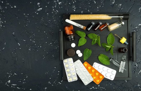 Fresh mint and drugs on the board. View from above. Copy space