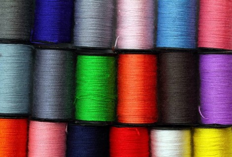 Lot of colored thread spools, background