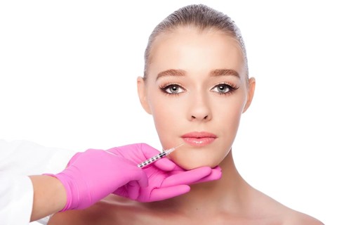 Beautiful face lip filler collagen injection Cosmetic spa beauty treatment with pink gloves, on