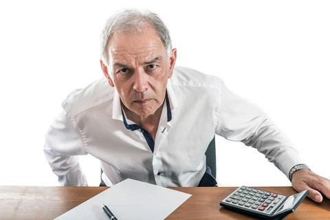 Man as civil servant, representative, lawyer or salesman looks grimly across the table