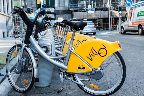 Belgium, 02 15 2019: Villo station with a row of yellow cycles for sharing and renting in the city,