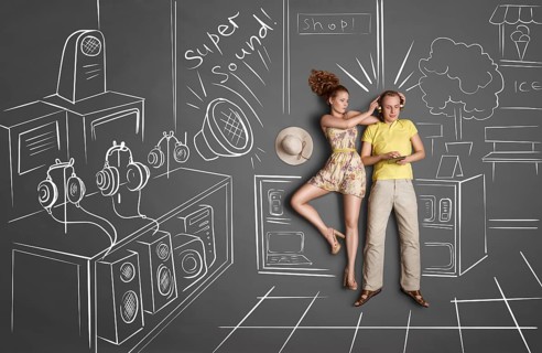 Love story concept of a romantic couple against chalk drawings background. Male listening to the