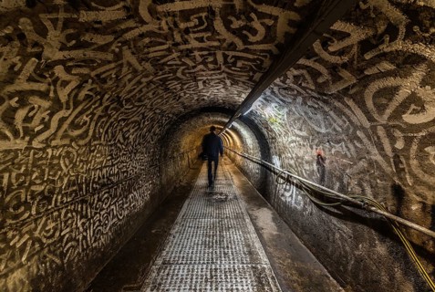 Anderlecht, Brussels, Belgium, 07 16 2019- Man walking in the industrial interiors of the sewer