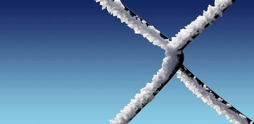 A chain-link fence with hoarfrost
