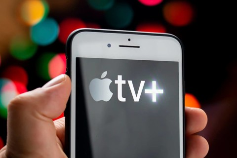 Calgary, Alberta, Canada. May 21, 2020. A person holding a white iPhone Plus with the Apple TV Plus
