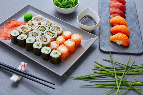 Sushi Maki and Niguiri California roll with seaweed chuka salad soy sauce and wasabi