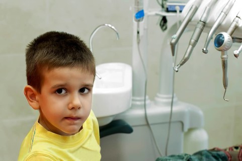 Child in a dentist's chair in cabinet