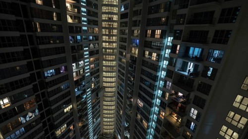 Lights in the windows of high-rise apartment block at night. Kuala Lumpur, Malaysia, Asia