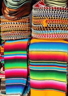Mexican serape colorful stacked and charro hats mariachi