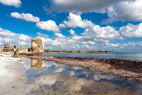 Scenic view of Saline tower against the scattered clouds at midday. Stintino, Sardinia. Italy