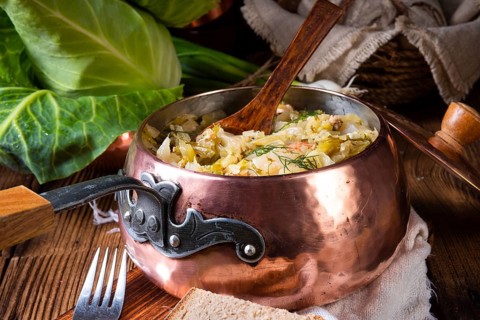 Young and fresh cabbage cooked with bacon cubes