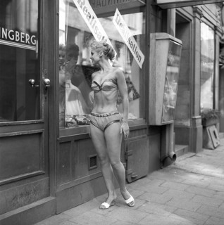In the 1950s. A young woman dressed in underwear. She is wearing a bra and panties and is standing