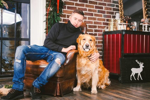 The theme is the friendship of man and animal. Caucasian young male and pet dog breed Labrador
