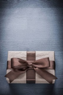 Present box on vintage wood board copy space holiday concept
