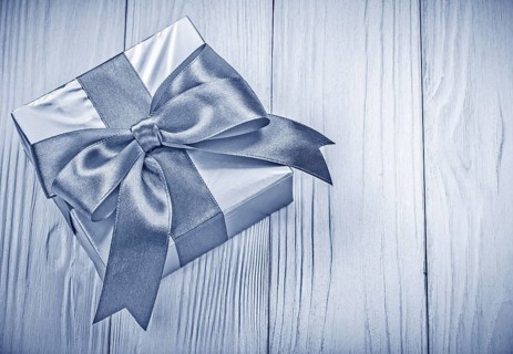 Packaged gift box on wooden board top view holidays concept