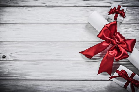 Paper roll with red ribbon present boxes holidays concept