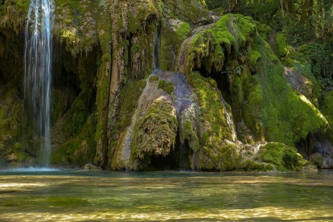 The tufa waterfall near Arbois. Crystal clear waterfall, powerful waterfall