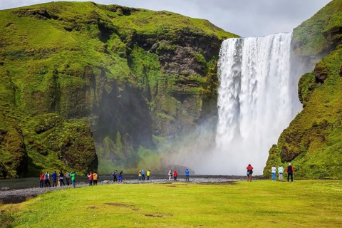 Magnificent famous waterfall Skógafoss, Iceland. A powerful jet Skógar river falls from a large
