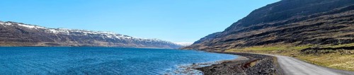 Panoramic view of a gravelled road at a fjord, Westfjords of Iceland