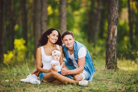 The theme family outdoor recreation in forest park area. Young beautiful stylish caucasian family