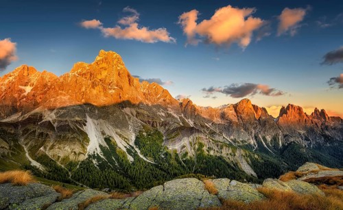 Cimon delle Pala mountain above Passo Rolle with red clouds at sunset