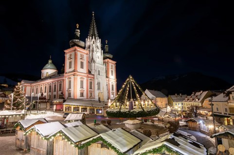 Christmas market in front of the basilica on the main square, night shot, Mariazell, Upper Styria,