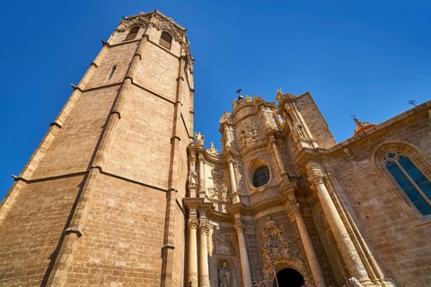 Valencia Cathedral main door and Miguelete tower at Plaza de la Reina sq Spain