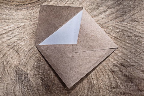 Vintage envelope on wooden board top view