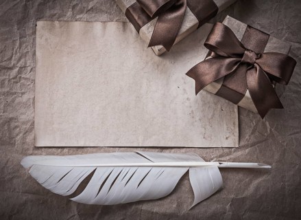 Wrapped present boxes sheet of wrapping paper plume celebration concept