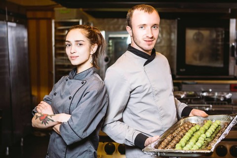 Profession preparation confectionery products. Caucasian man and woman two employees colleague