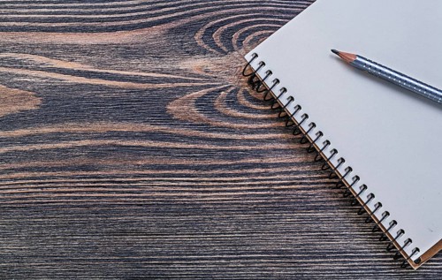 Open notepad pencil on vintage wooden board education concept