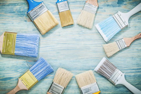 Paintbrushes on wooden board construction concept