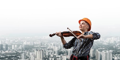 Beautiful young woman in safety helmet playing violin. Smiling professional female builder in