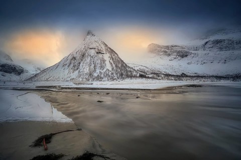 Beautiful winter landscape scene in Ersfjord and mountain in background in Northern Norway. sunset