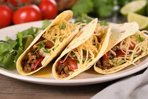 Taco with ground beef and avocado, cabbage and cheese. Mexican cuisine