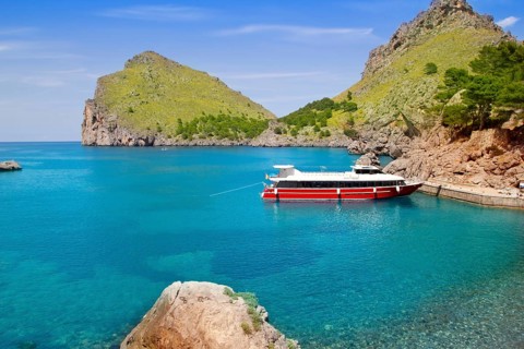 Escorca Sacalobra beach in north Mallorca with boat in balearic Spain