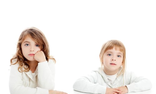Blond and brunette kid girls portrait on white desk table