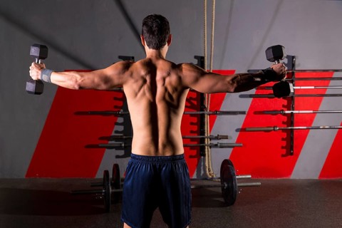 Hex dumbbells man workout rear view back exercise at gym box