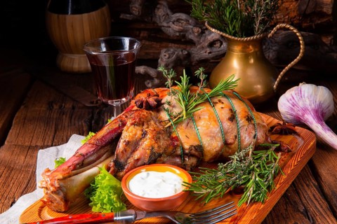 Grilled shoulder of lamb braised in the oven with rosemary