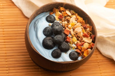 Healthy breakfast concept with flakes, blue spirulina and fresh berries