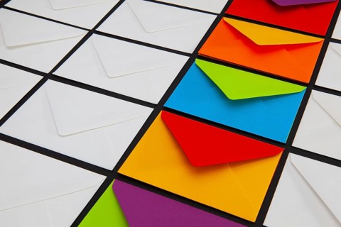 Composition with white and colored envelopes on the table. The photo suitable for various holidays