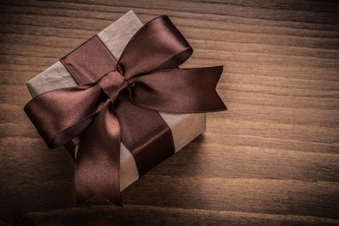 Wrapped gift on vintage wood board horizontal view holidays concept