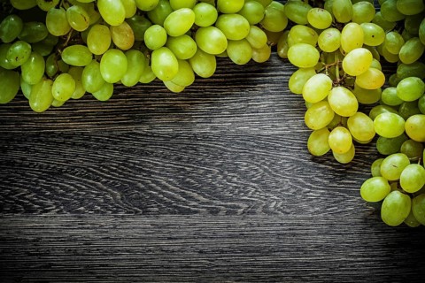 Branch of grapes on wooden board food concept