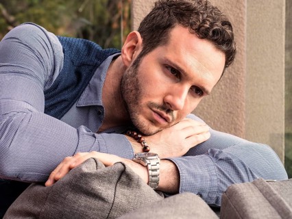Handsome elegant man at home, wearing shirt and vest, looking away to a side